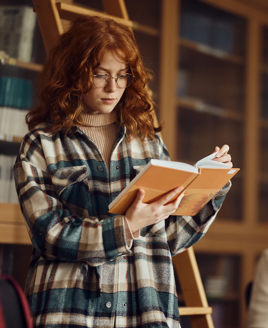 Woman in plaid shirt reading